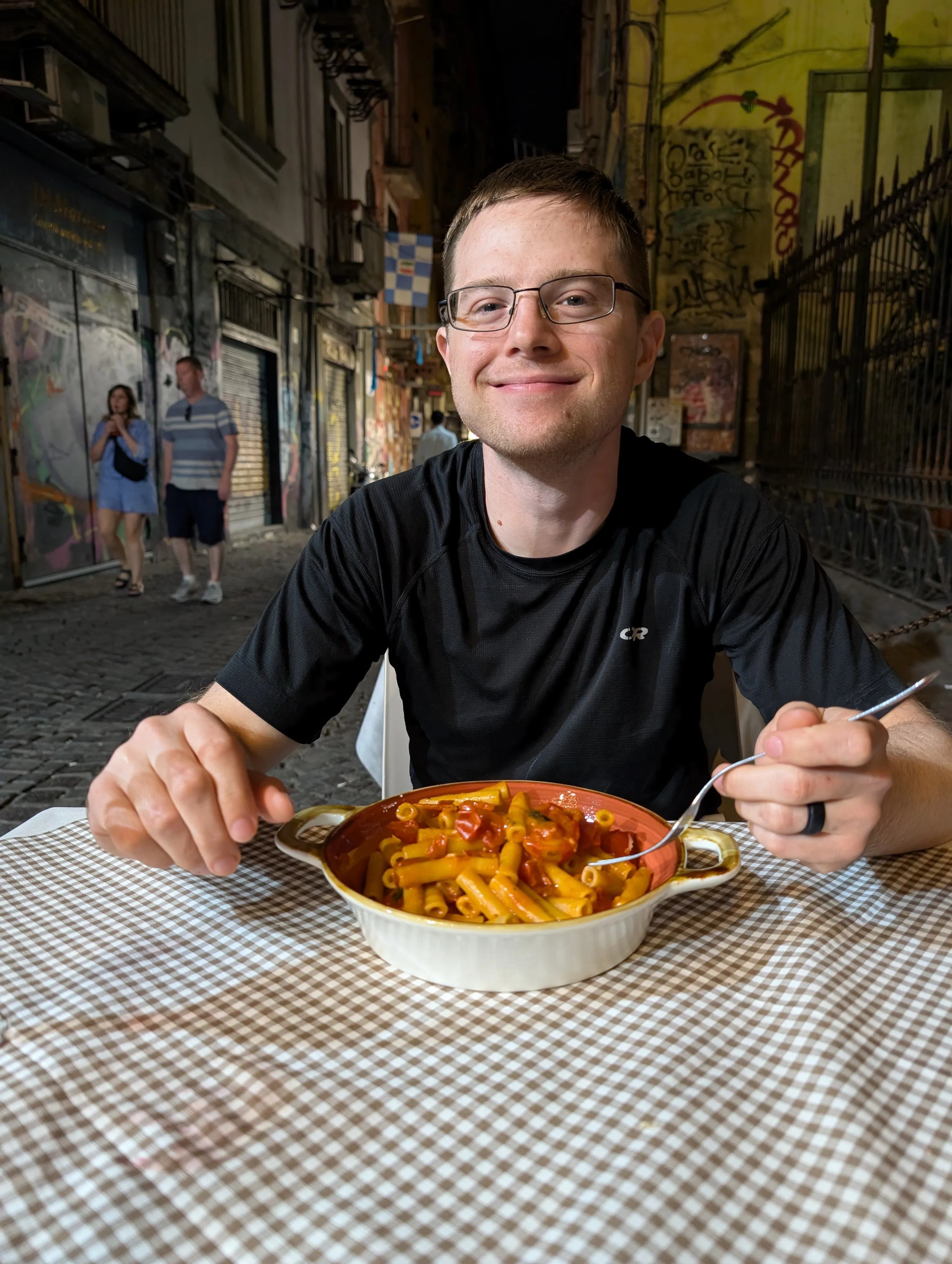 Travis, eating pasta on the street