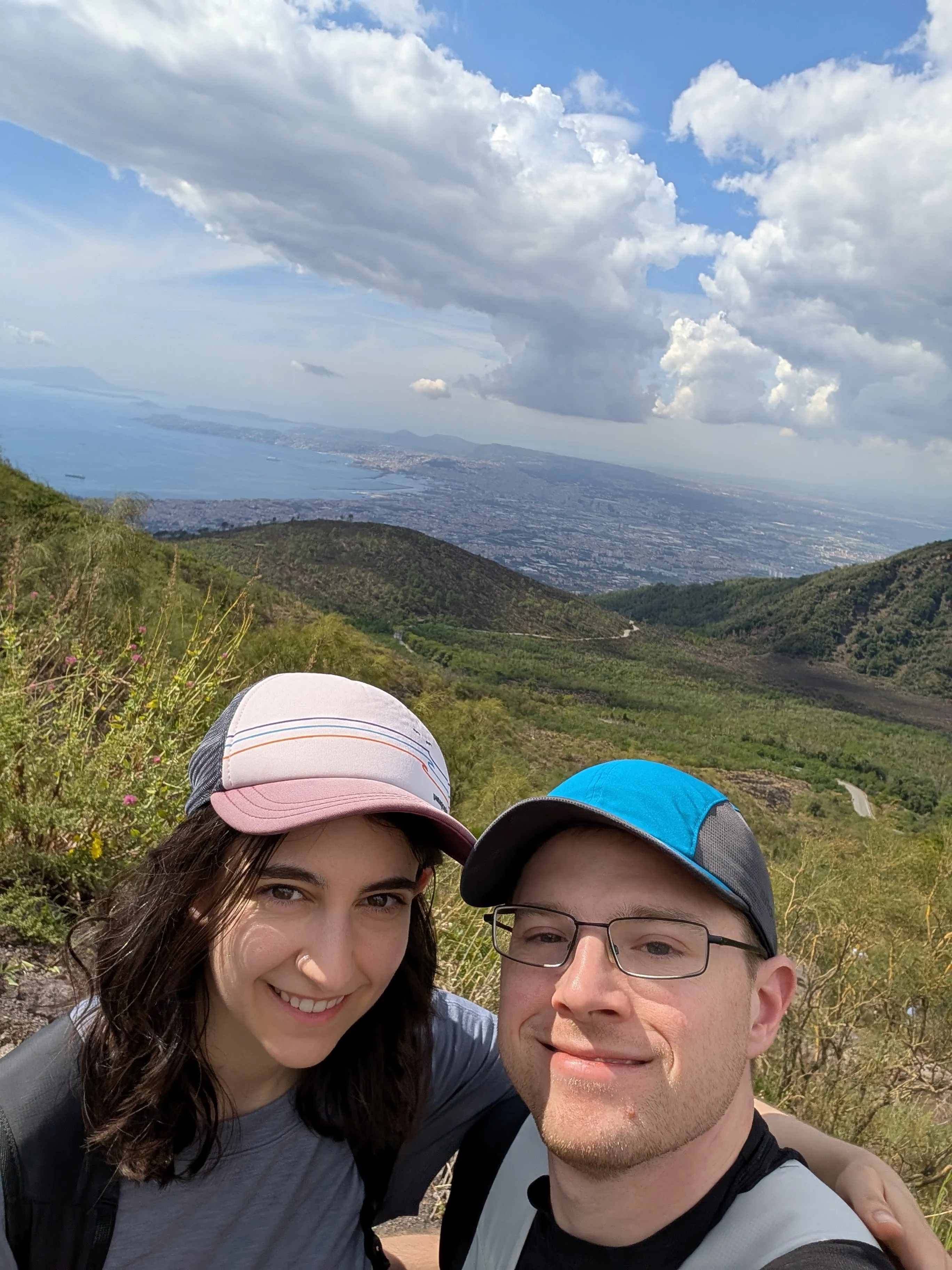 portrait on mountain trail with ocean in the background